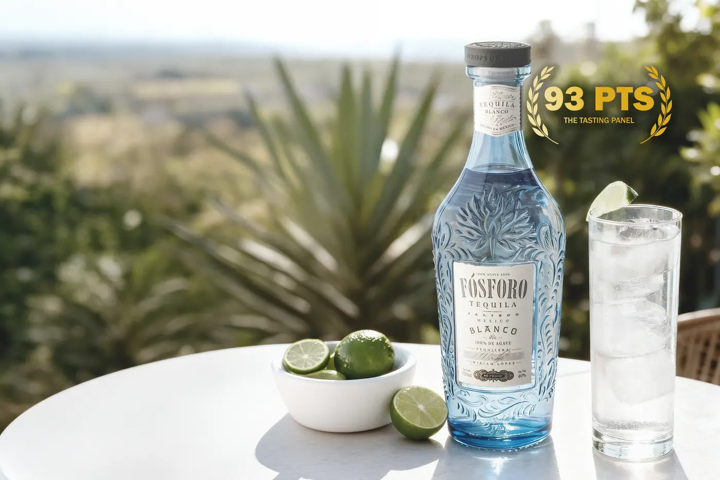 Fósforo Tequila Blanco — frosted blue embossed bottle from Los Altos, Jalisco, with 93 PTS Tasting Panel badge, served alongside a highball with lime